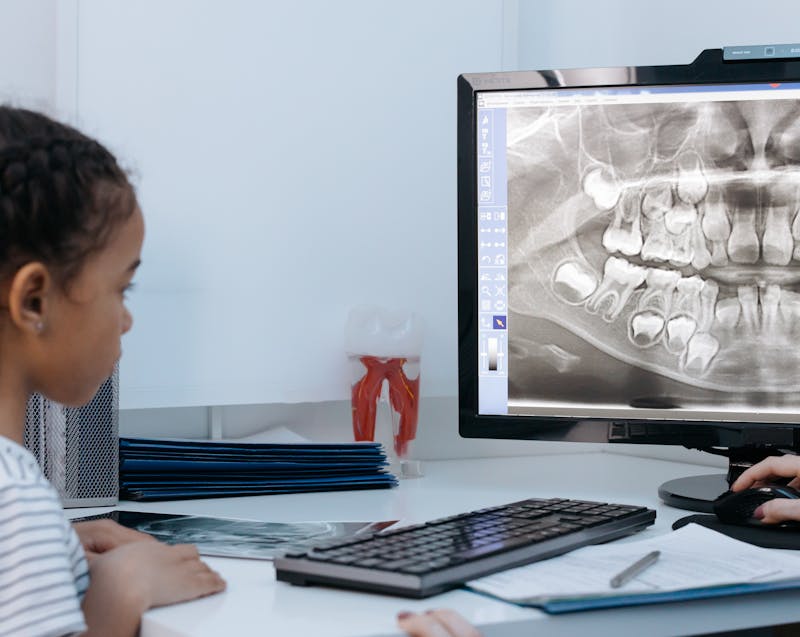 a girl looking at the dental X-ray results