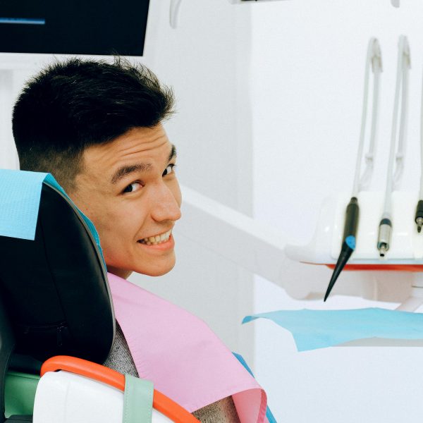 man sitting in dental chair in dentist office